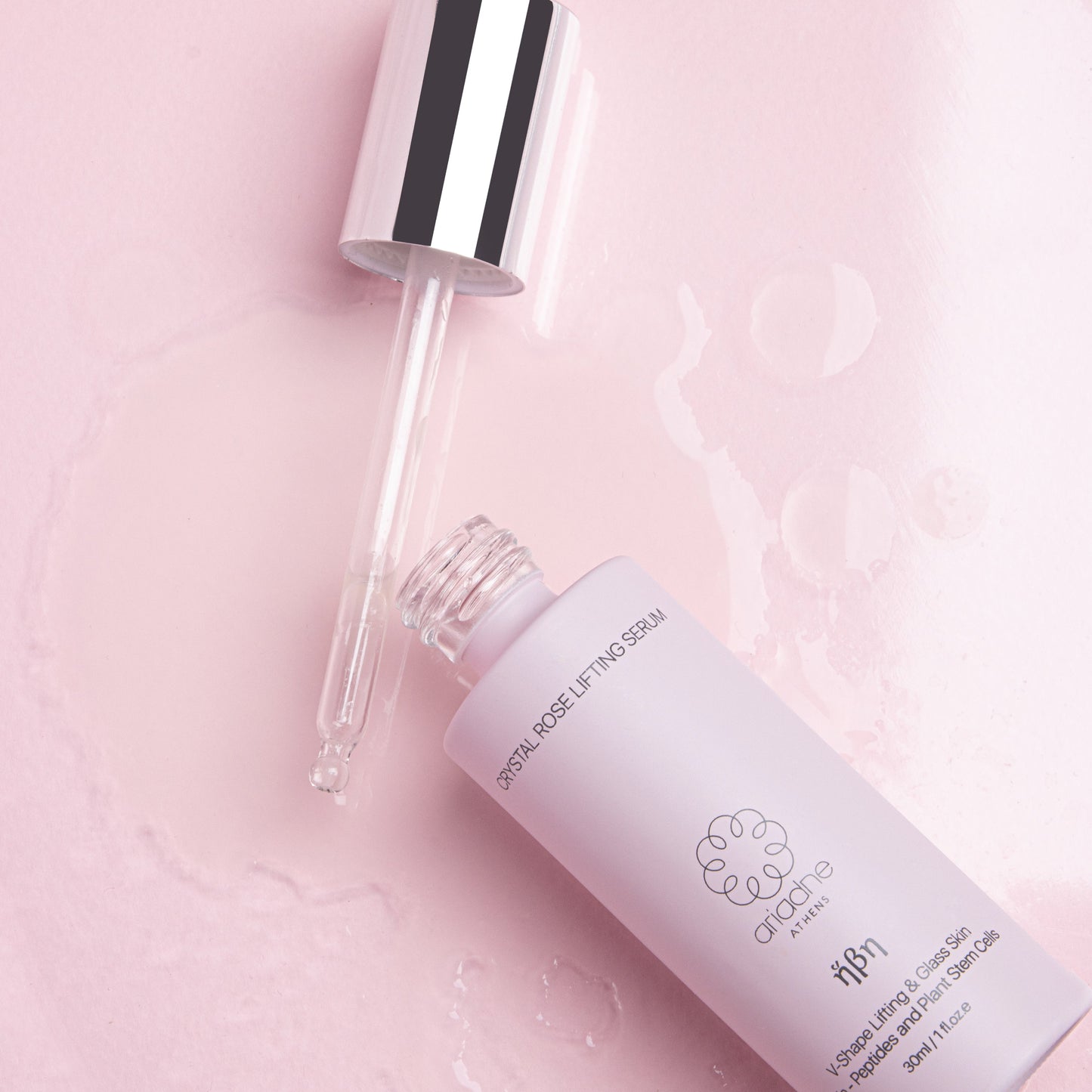 The Crystal Rose Lifting Serum bottle in use.