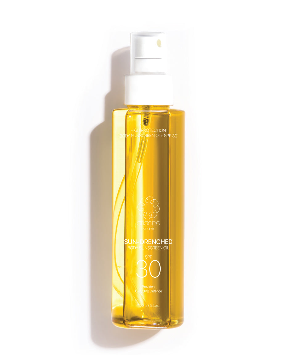 A bottle of Sun Drenched Sunscreen Oil front side.